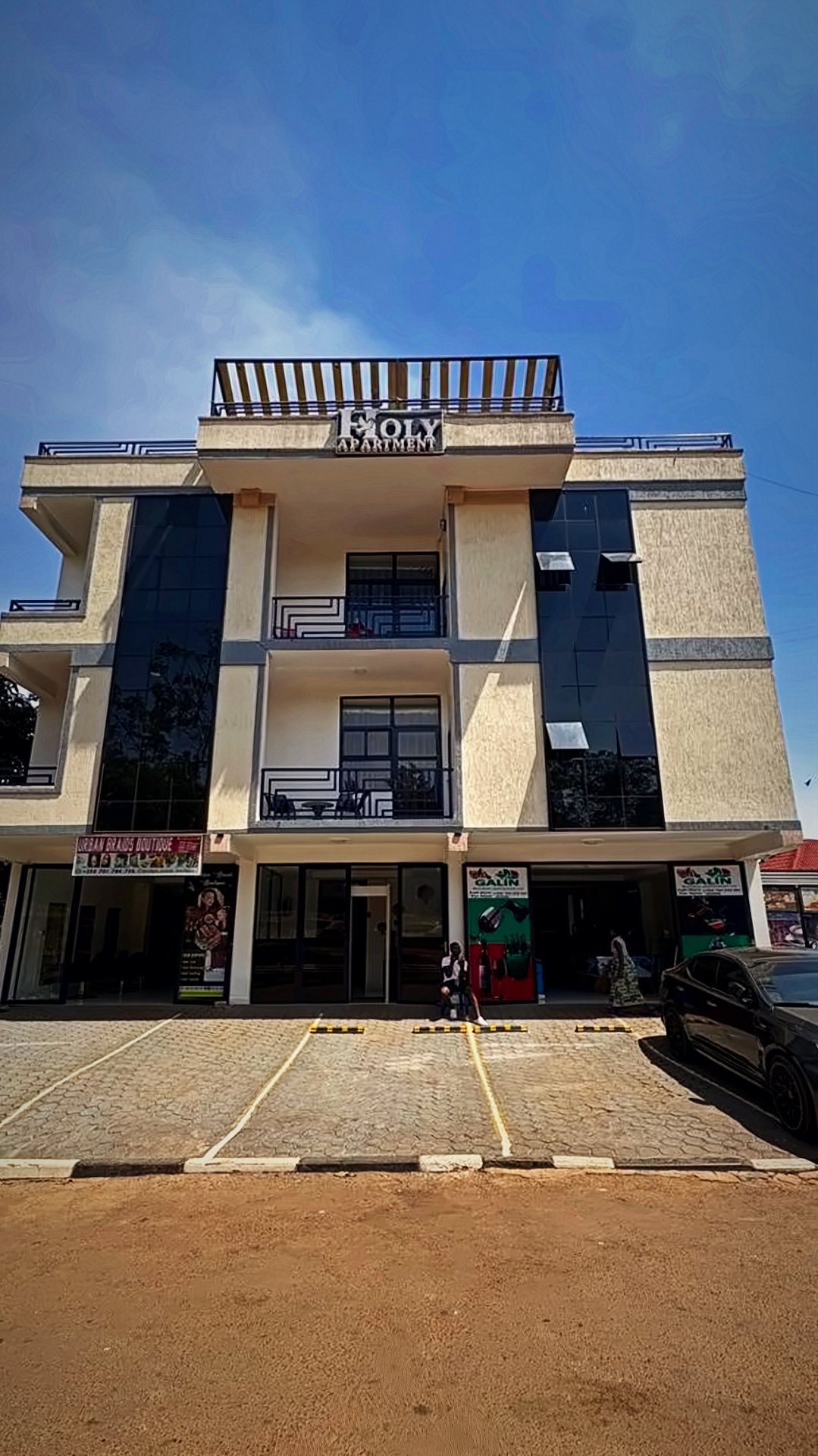 Holy Apartments building in Kigali showing balconies and the rooftop terrace
