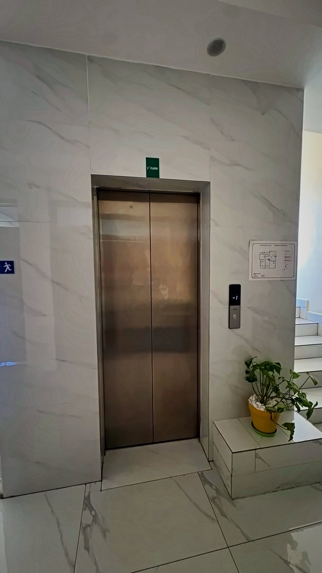 Stainless-steel lift in the marble lobby at Holy Apartments, Kigali